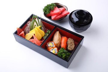 Sushi Set in wooden Bento (Japanese lunchbox) isolated on white background.
