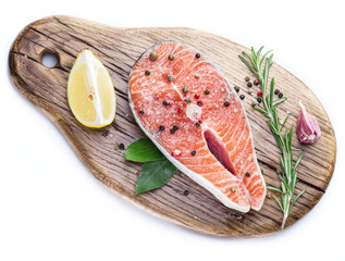 Salmon steak on the cutting board on white background.