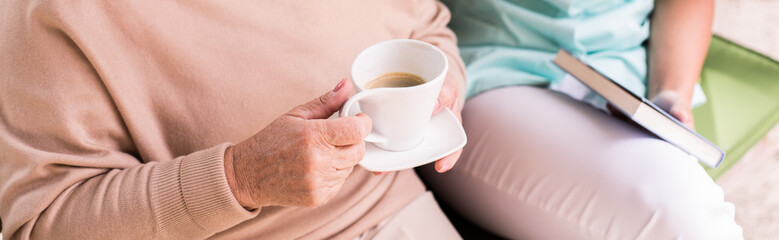 Elderly woman drinking coffee