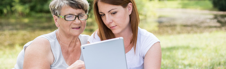 Young woman teaching grandma