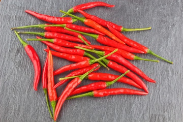 Hot Red Chili Pepper/Hot red chili pepper on a black stone surface
