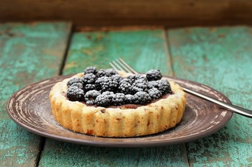 Tasty homemade vegan cake with fresh juicy blackberries and icin