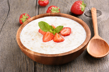 Tasty oatmeal with strawberry slices