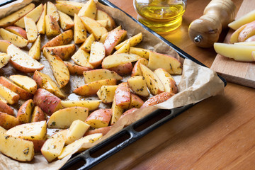 Raw potato for cooking in oven with herbs and olive oil