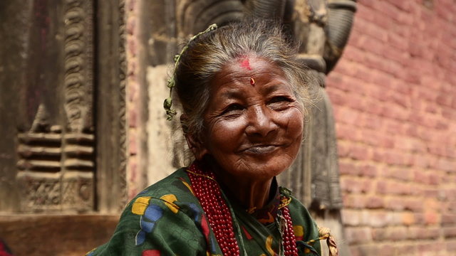 Old woman on the steps of the temple