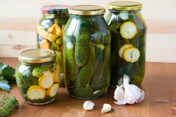 Preserved cucumbers and other vegetables in glass jars. Traditional Russian appetizer © lovelymama