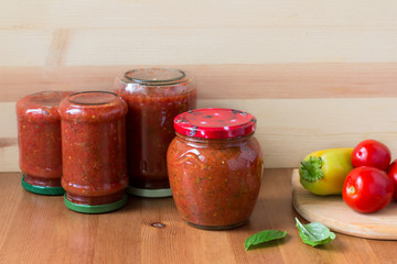 Homemade preserved tomato sauce with bell pepper, basil and oregano in a glass jar