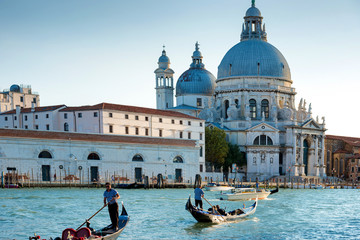 Fototapeta na wymiar Gondoliers at Grand Canal in Venice