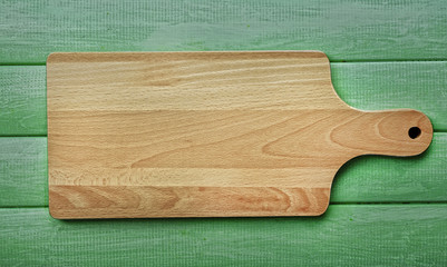 Cutting board on wooden background