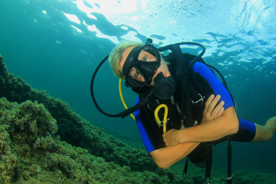 Beautiful blonde woman scuba diving