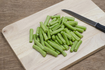 cow-pea on wood background and knife