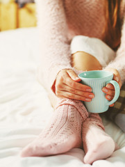 Woman relaxing at cozy home atmosphere on the bed. Young woman w