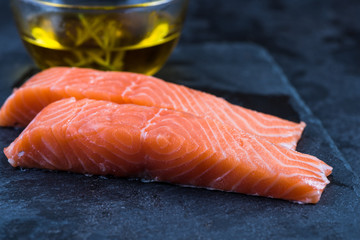 fresh salmon steaks on slate board