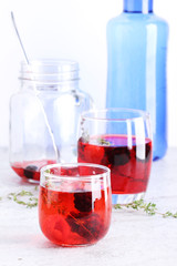 glass of berry drink with fresh fruits on marble table
