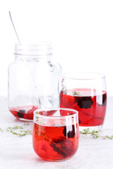 glass of berry drink with fresh fruits on marble table