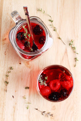 glass of berry drink with fresh fruits