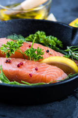 salmon steaks with herbs on rustic pan
