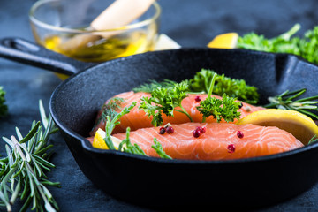 salmon steaks with herbs on rustic pan