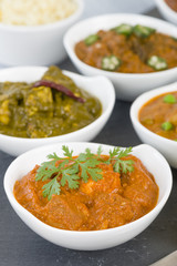 Paneer Makhani - Indian cheese cooked in a creamy sauce. Chapattis and other vegetarian curries on background.
