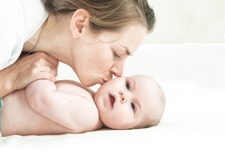 Mother kissing newborn baby