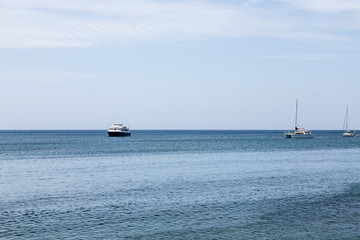 Obraz premium Ferry with Sailboats on Blue