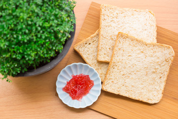 Bread with jam, strawberry tasty dishes on a wood floor. Ready to eat in the morning The appetizers are not hungry