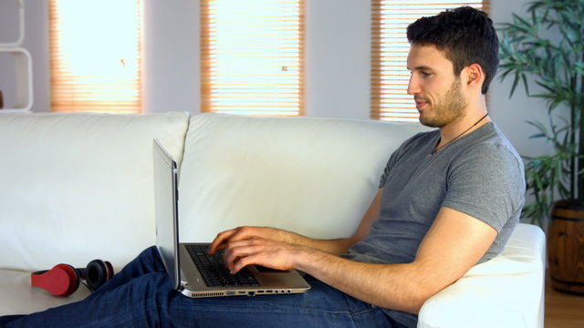 Man using his laptop on the couch