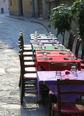 restaurant with the tables prepared along the pedestrian street