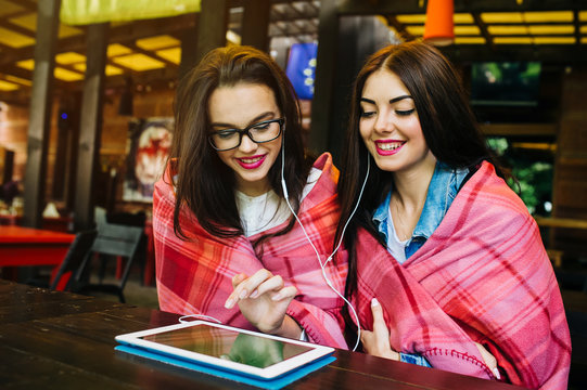 Two Close Friends Watching Something On A Tablet