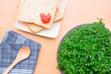 Bread with jam, strawberry tasty dishes on a wood floor. Ready to eat in the morning The appetizers are not hungry