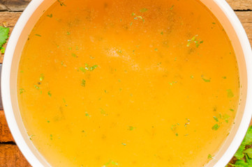 Closeup of broth, clear soup or bouillon  in a saucepan