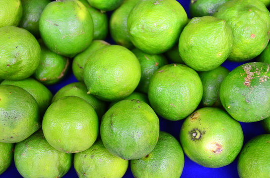Green colored fruits are on grocery shelf.