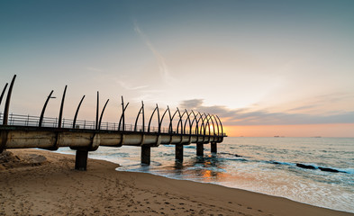 View of the Indian Ocean through the Millennium Pier in Umhlanga Rocks at Sunrise - obrazy, fototapety, plakaty