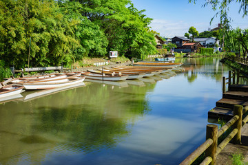 A tour boat cruising on the river Yanagawa in Japan.
