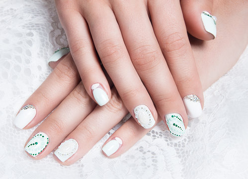 Wedding manicure for the bride in gentle tones with flowers