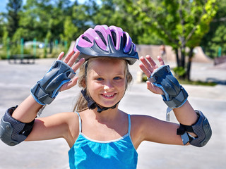 Girl riding on roller skates .