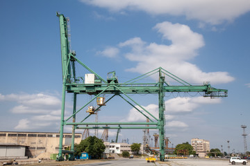 Fototapeta na wymiar Container crane in Industrial Port. Cloudy sky
