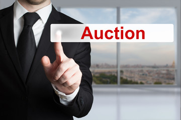businessman pushing button auction