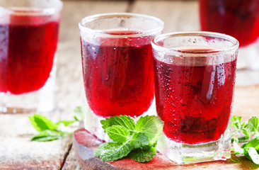Pomegranate red cocktail with mint, selective focus