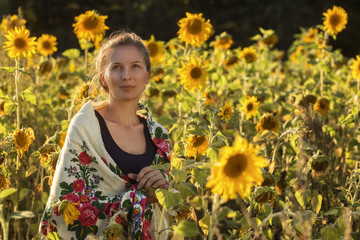A girl among sunflowers