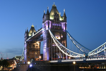 Fototapeta na wymiar World famous Historic Tower Bridge in London, UK at night with light trail of red bus, long exposure artistic shot