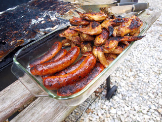 chicken and sausage cooked on a grill