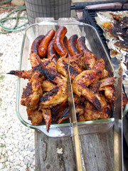 chicken and sausage cooked on a grill