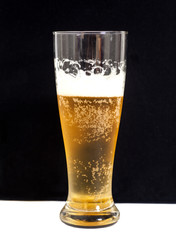 Glass of beer on black background