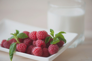Raspberry yogurt with mint leaves