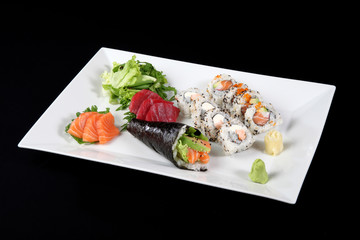 sushi and sashimi with wasabi and vegetable in white plate