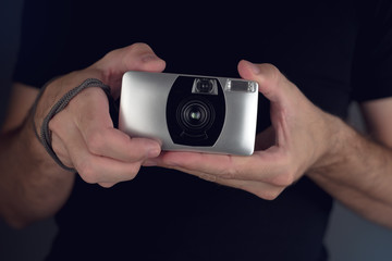 Man taking picture with vintage film camera