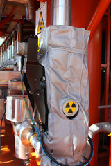 Flow meter, with high radiation sign.