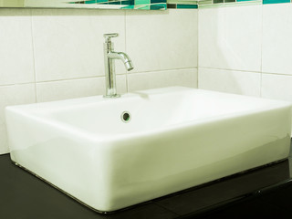Faucet with handle and white sink