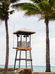 guardian tower on the sea beach and palm trees